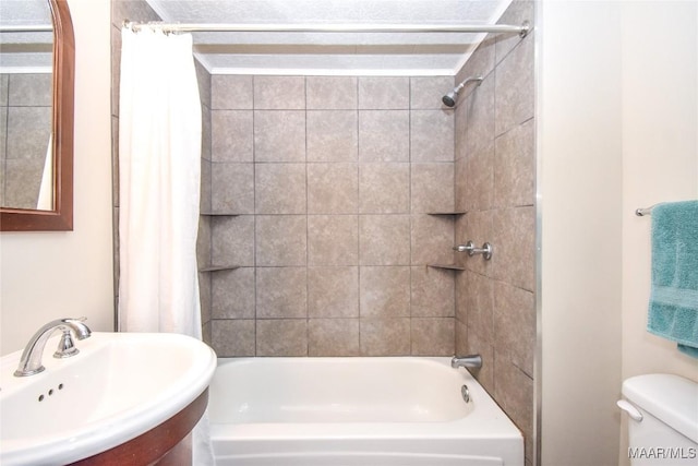 full bathroom with sink, shower / bath combo, and toilet