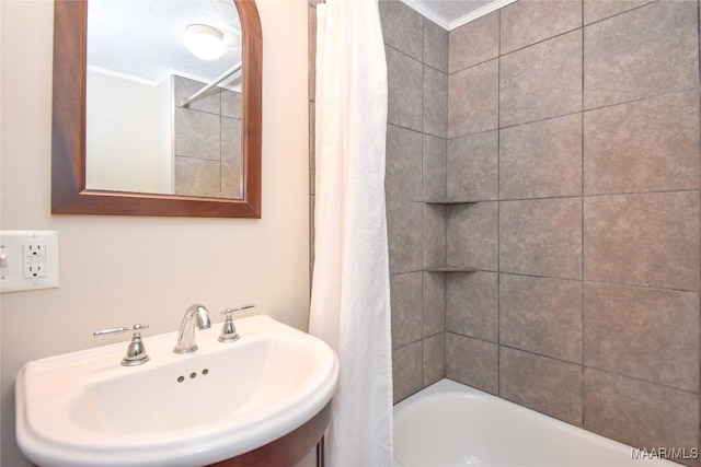 bathroom featuring sink, shower / bath combo, and ornamental molding