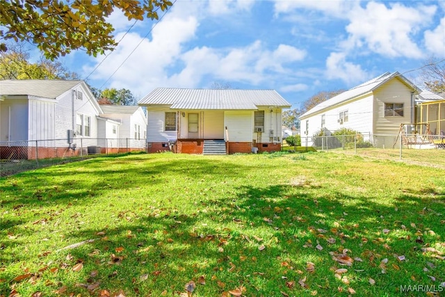 back of property featuring a yard and a porch