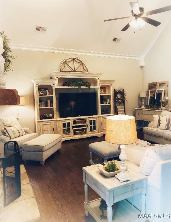 living room featuring wood-type flooring and ornamental molding