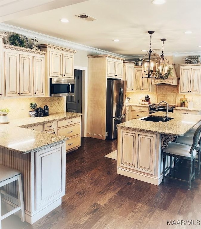 kitchen with a kitchen breakfast bar, dark hardwood / wood-style floors, crown molding, and appliances with stainless steel finishes