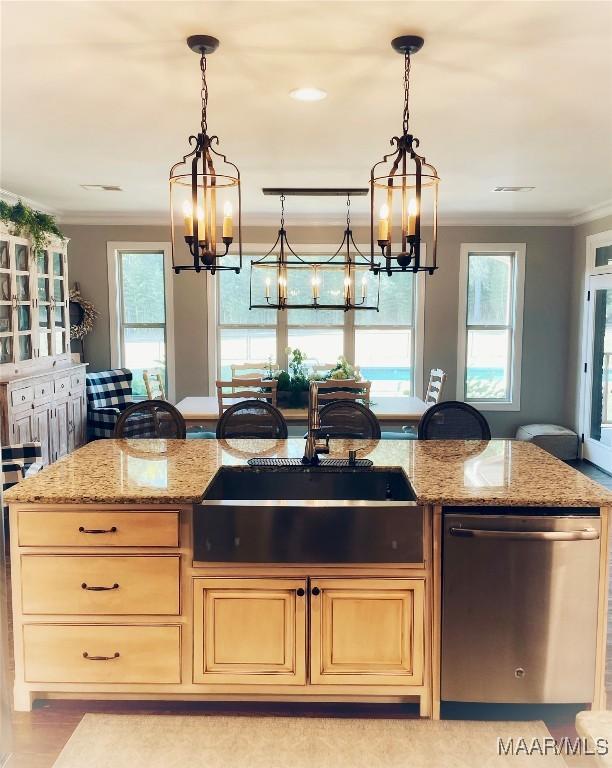 kitchen featuring dishwasher, light stone counters, and a wealth of natural light