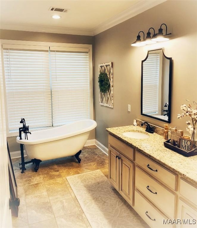 bathroom featuring a tub, crown molding, and vanity