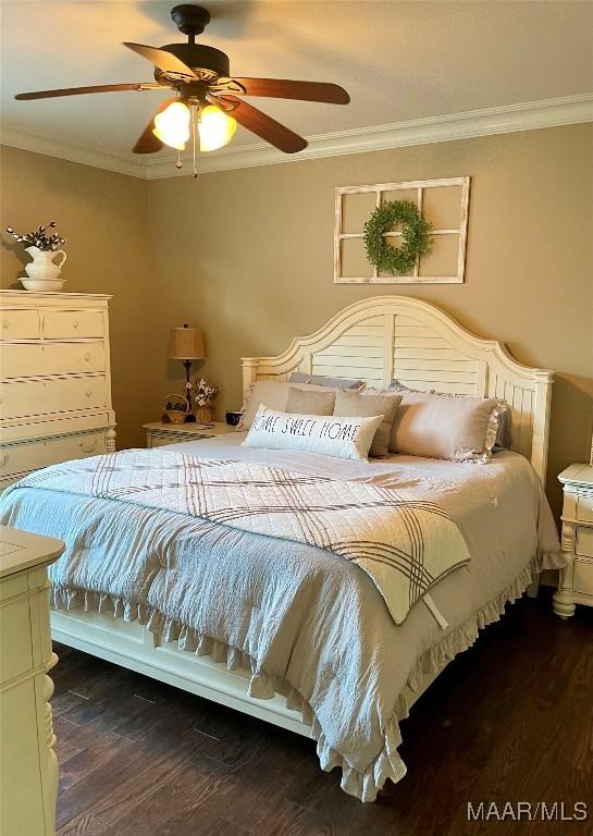 bedroom featuring ornamental molding, ceiling fan, and dark wood-type flooring