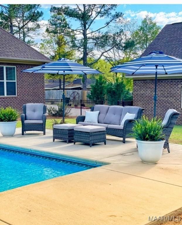 view of swimming pool featuring a patio area