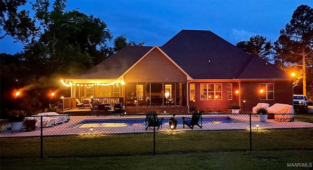 back of house with a lawn and a pool side deck