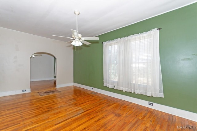 empty room featuring hardwood / wood-style flooring and ceiling fan