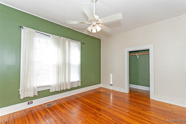 unfurnished room with hardwood / wood-style flooring and ceiling fan