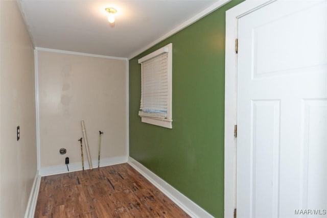 laundry area with dark hardwood / wood-style floors and ornamental molding