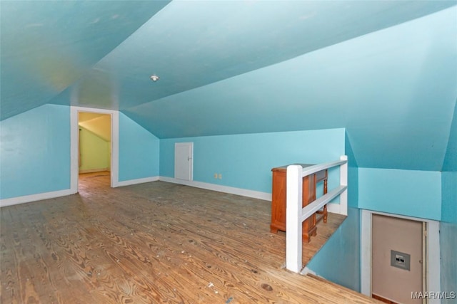 bonus room featuring hardwood / wood-style flooring and vaulted ceiling