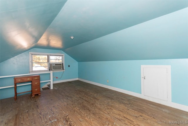 additional living space featuring cooling unit, dark hardwood / wood-style flooring, and vaulted ceiling