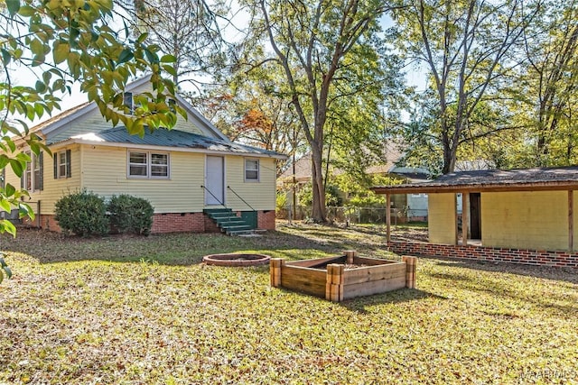 rear view of property with a yard