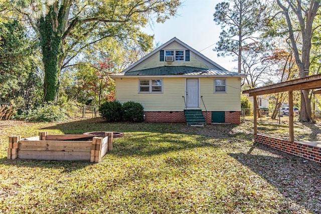 rear view of house with a yard