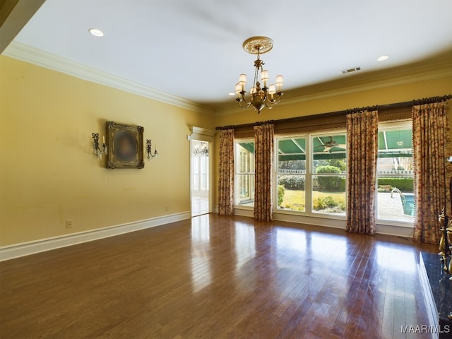 unfurnished room with a notable chandelier, ornamental molding, and dark wood-type flooring