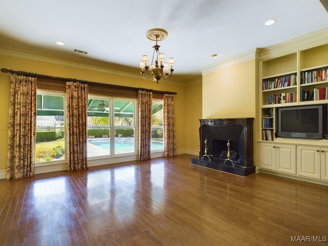 unfurnished living room featuring crown molding, a fireplace, a chandelier, and dark hardwood / wood-style floors