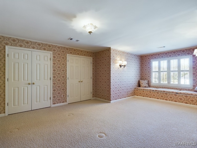 carpeted spare room with crown molding