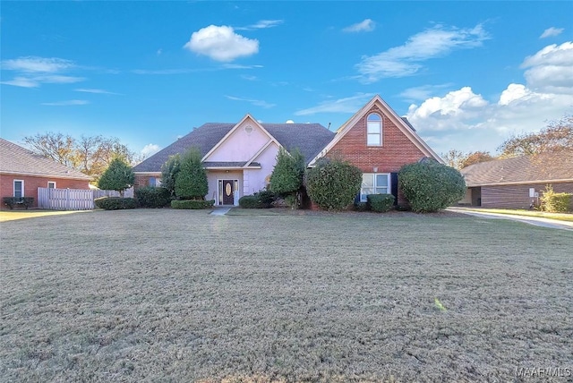 view of property featuring a front lawn