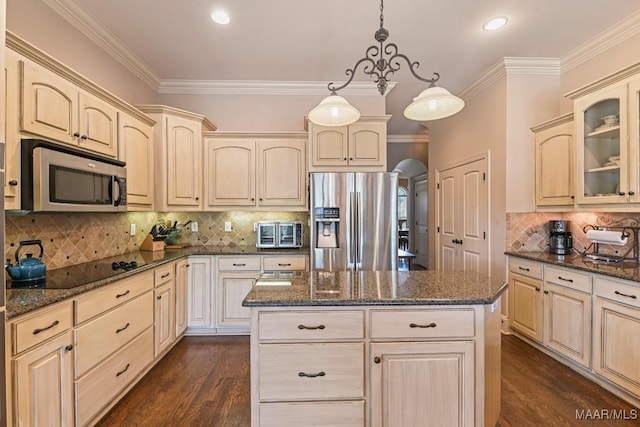 kitchen featuring pendant lighting, a center island, dark wood-type flooring, and appliances with stainless steel finishes