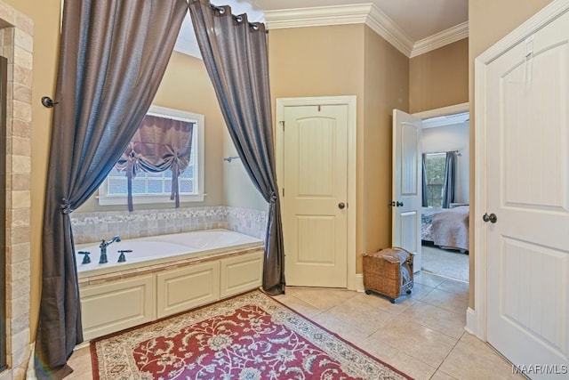 bathroom with tile patterned floors, a bath, and ornamental molding