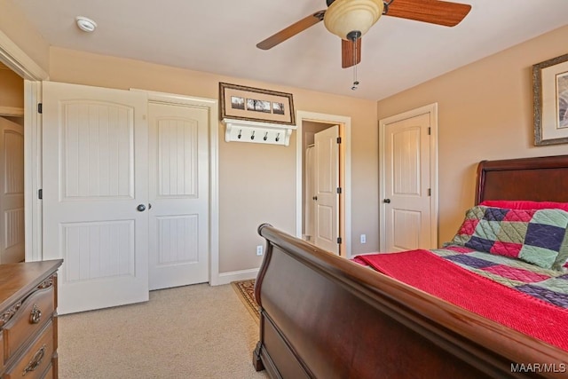 carpeted bedroom featuring ceiling fan and a closet