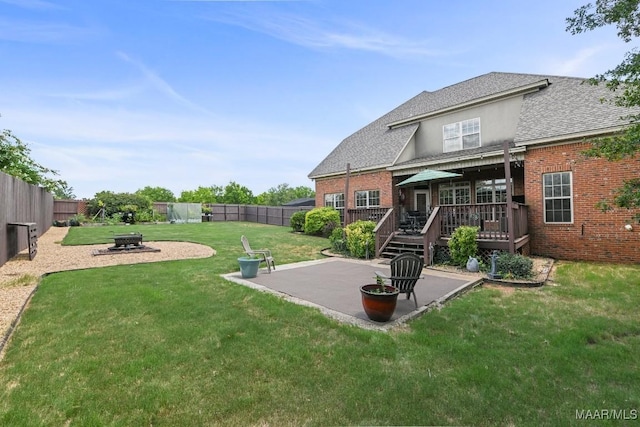 view of yard with an outdoor fire pit, a patio, and a deck