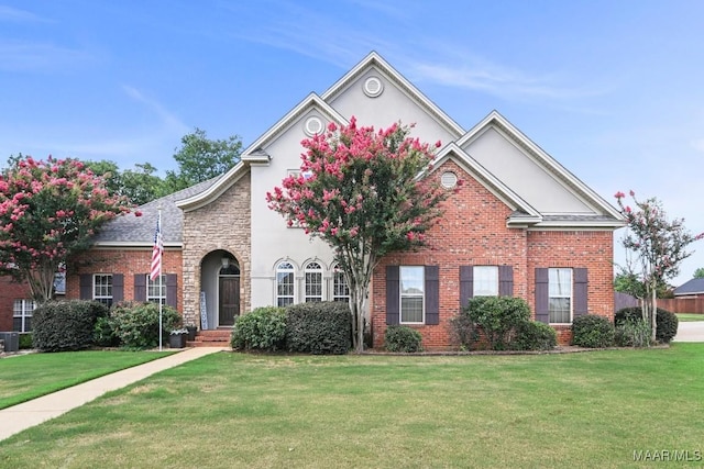 view of front of home featuring a front yard and central AC