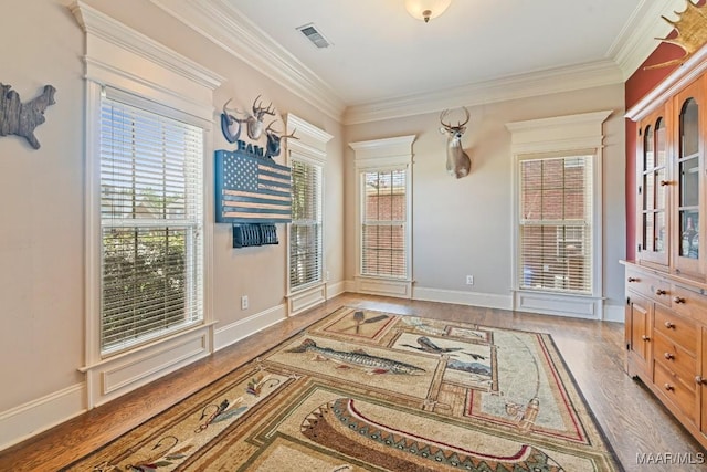 interior space featuring hardwood / wood-style flooring and ornamental molding