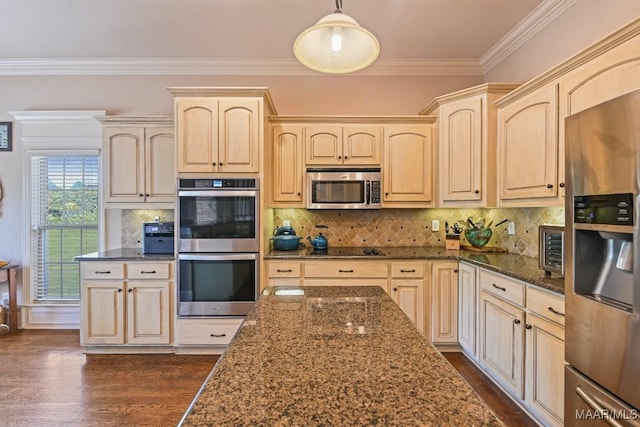 kitchen featuring backsplash, hanging light fixtures, dark hardwood / wood-style floors, dark stone countertops, and stainless steel appliances