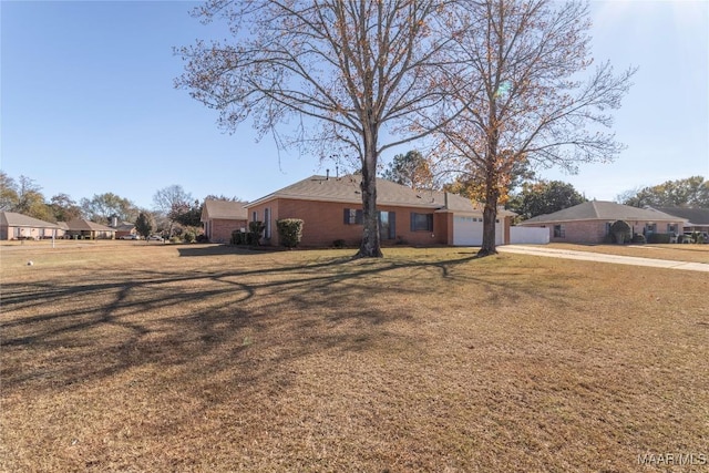 ranch-style house with a front lawn and a garage