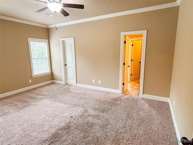 carpeted empty room featuring ceiling fan and ornamental molding