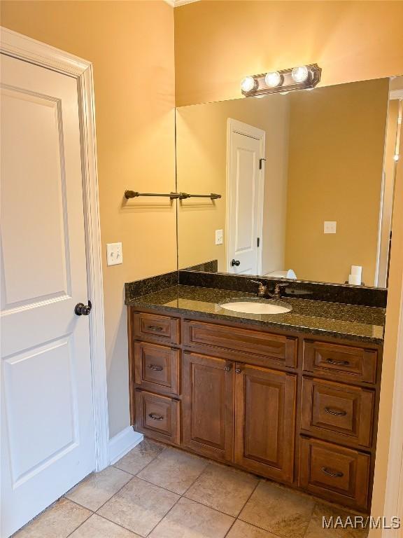 bathroom with tile patterned floors and vanity