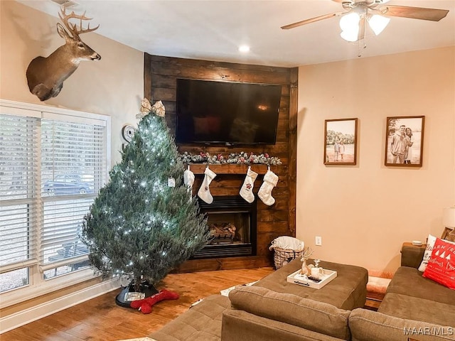 living room featuring hardwood / wood-style floors, ceiling fan, and a healthy amount of sunlight