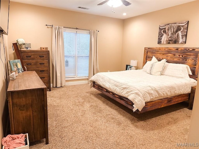 bedroom with ceiling fan and light carpet