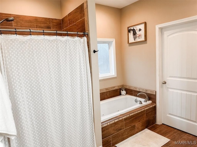 bathroom featuring hardwood / wood-style flooring and separate shower and tub