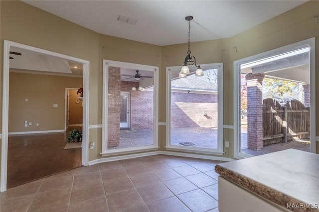 unfurnished dining area with ornamental molding, ceiling fan with notable chandelier, and hardwood / wood-style flooring