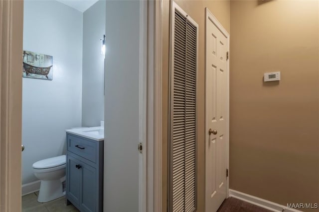 bathroom featuring tile patterned flooring, vanity, and toilet