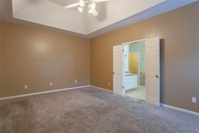 unfurnished bedroom with connected bathroom, ceiling fan, and light colored carpet