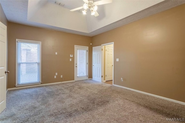 empty room featuring ceiling fan, light colored carpet, and a textured ceiling