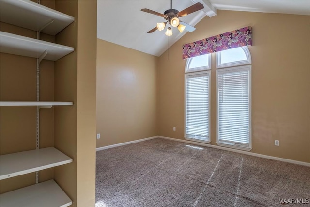 carpeted spare room featuring vaulted ceiling with beams and ceiling fan