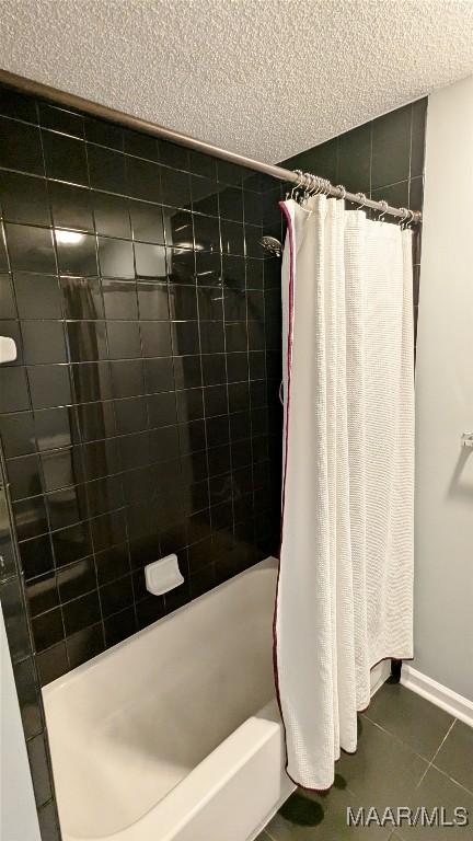 bathroom with tile patterned flooring and shower / tub combo