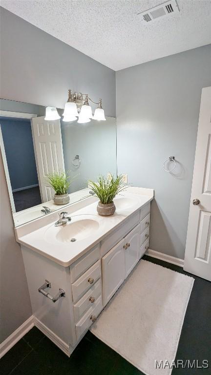 bathroom featuring vanity and a textured ceiling