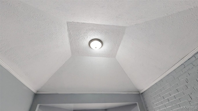 interior details featuring a textured ceiling and crown molding