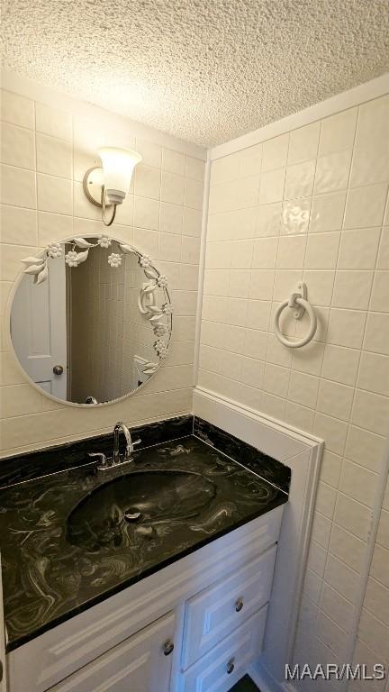 bathroom with a textured ceiling and vanity