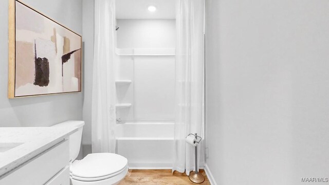 full bathroom with shower / tub combination, vanity, wood-type flooring, and toilet