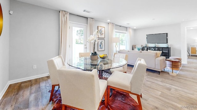 dining space with hardwood / wood-style flooring