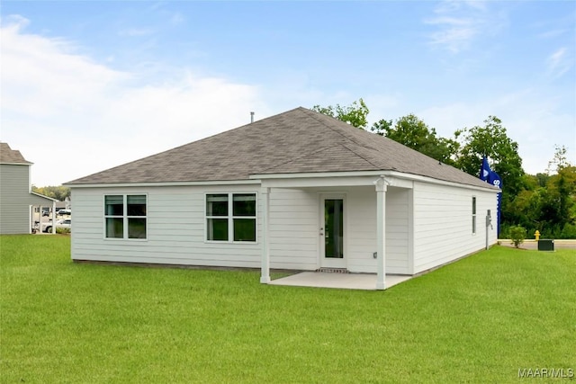 back of property with a patio area and a yard