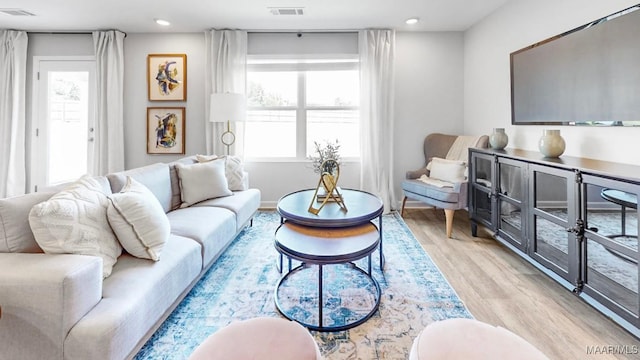 living room with light hardwood / wood-style flooring