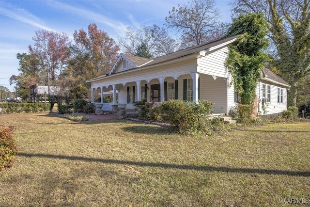 view of property exterior with a lawn and covered porch