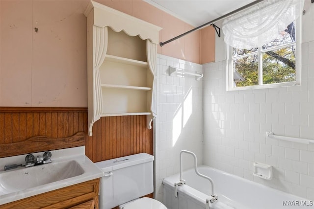 full bathroom featuring vanity, tiled shower / bath combo, and toilet