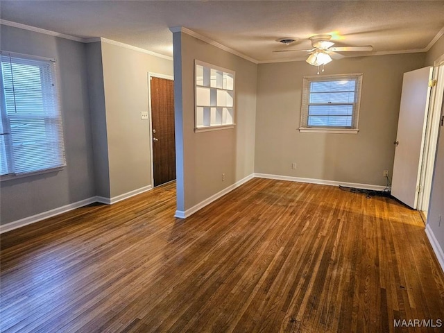 empty room featuring ceiling fan, crown molding, and dark wood-type flooring